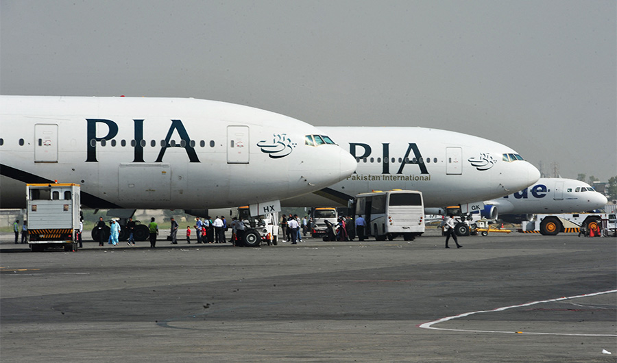 Pakistan International Airline (PIA) planes are positioned on the tarmac at the Benazir Bhutto International Airport in Islamabad on October 10, 2012. (AFP)