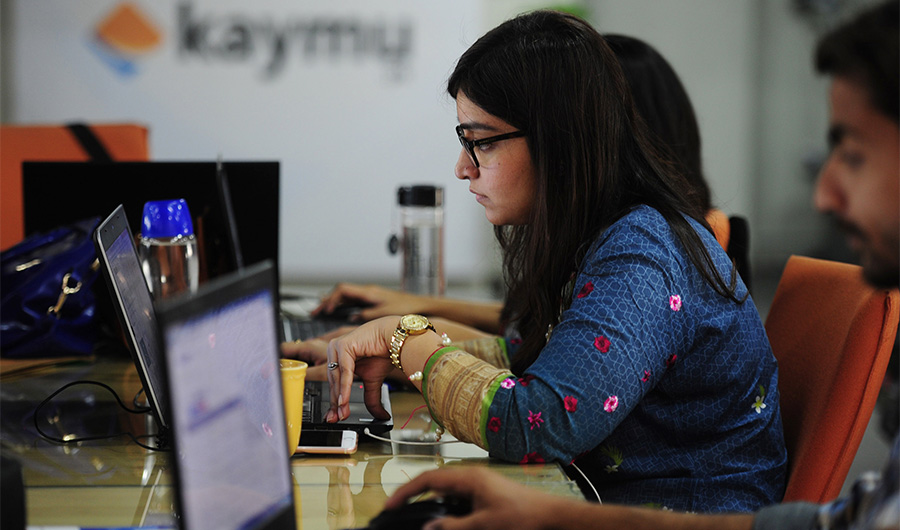This photograph taken on November 19, 2015 shows Pakistani employees of online marketplace company Kaymu at work in Karachi. (AFP/File)