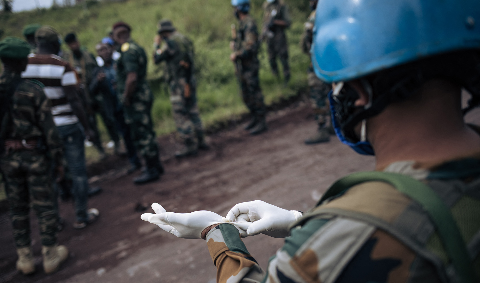 UN and Congo Armed Forces soldiers retrieve bodies of Italy's ambassador to the Democratic Republic of Congo, his bodyguard, and driver, during their field trip near Kibumba village on Feb. 22, 2021. (AP)