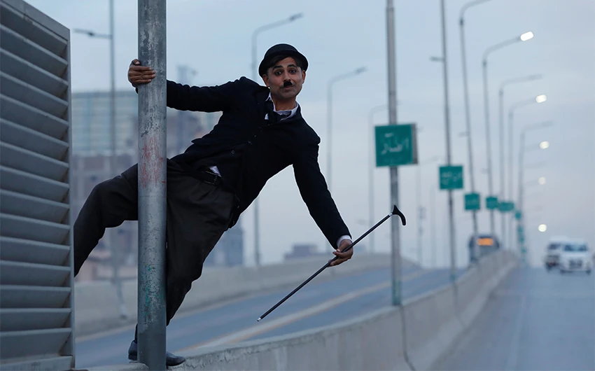 Usman Khan, 29, dressed up as Charlie Chaplin, performs along the street in Peshawar, Pakistan, on January 27, 2021. (REUTERS)