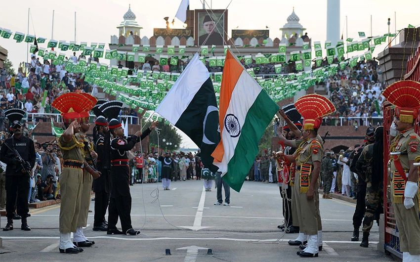 Pakistani Rangers (black uniforms) and Indian Border Security Force personnel (brown uniforms) perform during the daily beating of the retreat ceremony at the India-Pakistan Wagah Border Post, on October 30, 2017. (AFP/File)