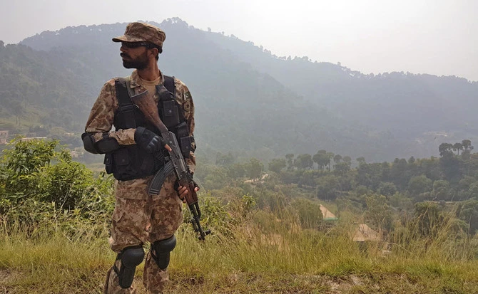 In this file photo, a Pakistani soldier patrols a village in district Bhimber near the Line of Control (LoC) in Pakistan-administered Kashmir during a media trip organized by the Pakistani army on Oct. 1, 2016. (AFP)