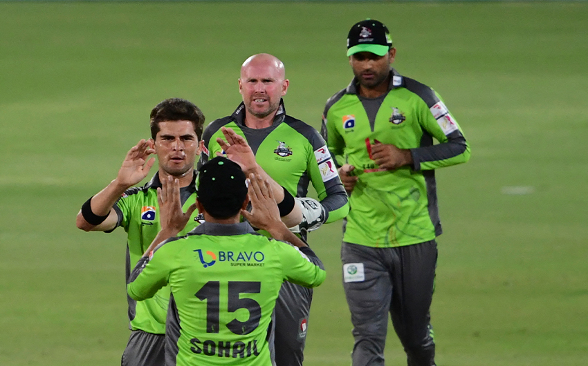Lahore Qalandars' Shaheen Afridi (L) celebrates in a match against Karachi Kings during the Pakistan Super League T20 cricket match at the National Stadium in Karachi, Pakistan, on February 28, 2021. (AFP)