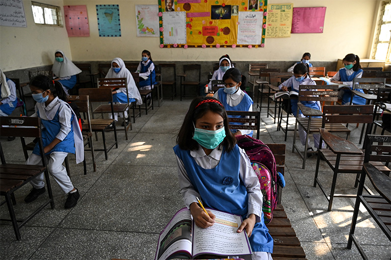 Children wearing facemasks attend a class at a school in Islamabad on September 30, 2020. (AFP)