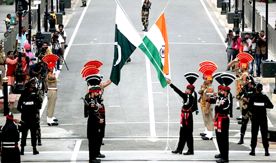 Pakistani rangers (wearing black uniforms) and Indian Border Security Force (BSF) officers lower their national flags during a daily parade at the Pakistan-India joint check-post at Wagah border, near Lahore November 3, 2014. (REUTERS)
