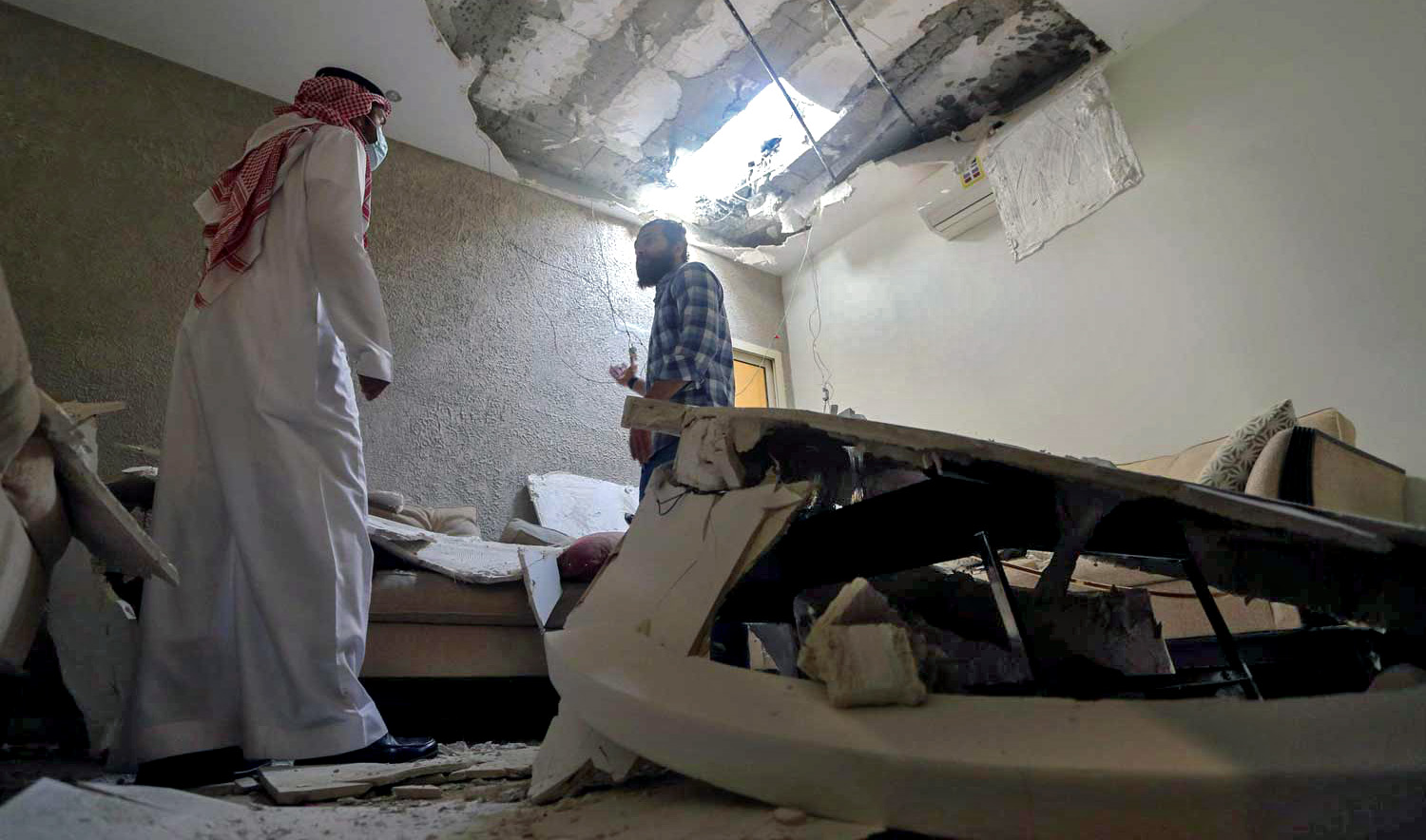 Mohamed Fahim inspects his house that was damaged by an intercepted missile in the aftermath of what Saudi-led coalition said was a thwarted Houthi missile attack, in Riyadh, Saudi Arabia, on February 28, 2021. (REUTERS/File)