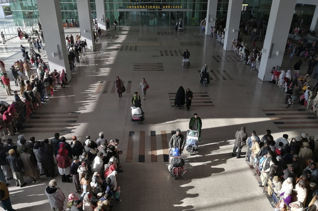People gather to receive arriving passengers at the international arrival area of Islamabad International Airport in Islamabad on February 3, 2020. (AFP/File)