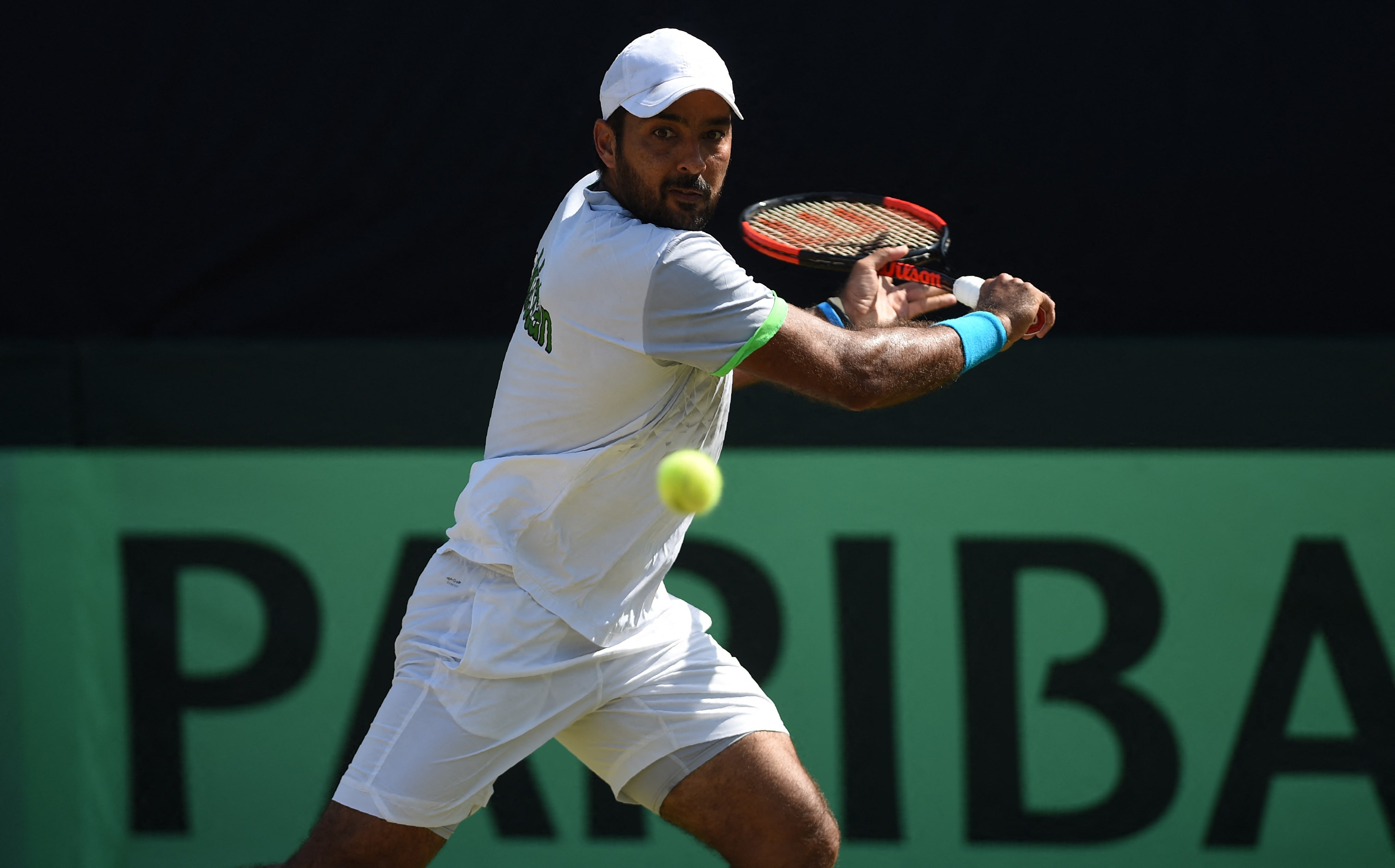 Pakistani Aisam Qureshi returns the ball to Thai opponent Trongcharoenchaikul Wishaya during the Davis Cup Asia-Oceania Group-II Tennis singles final match at the Sports Complex in Islamabad on September 17, 2017. (AFP)