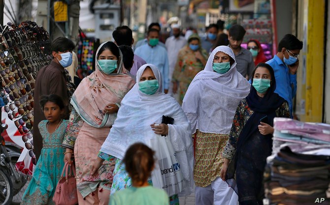 In this file photo a family wearing masks to help curb the spread of the coronavirus visits a market in Rawalpindi, Pakistan, June 2, 2020. (AP)