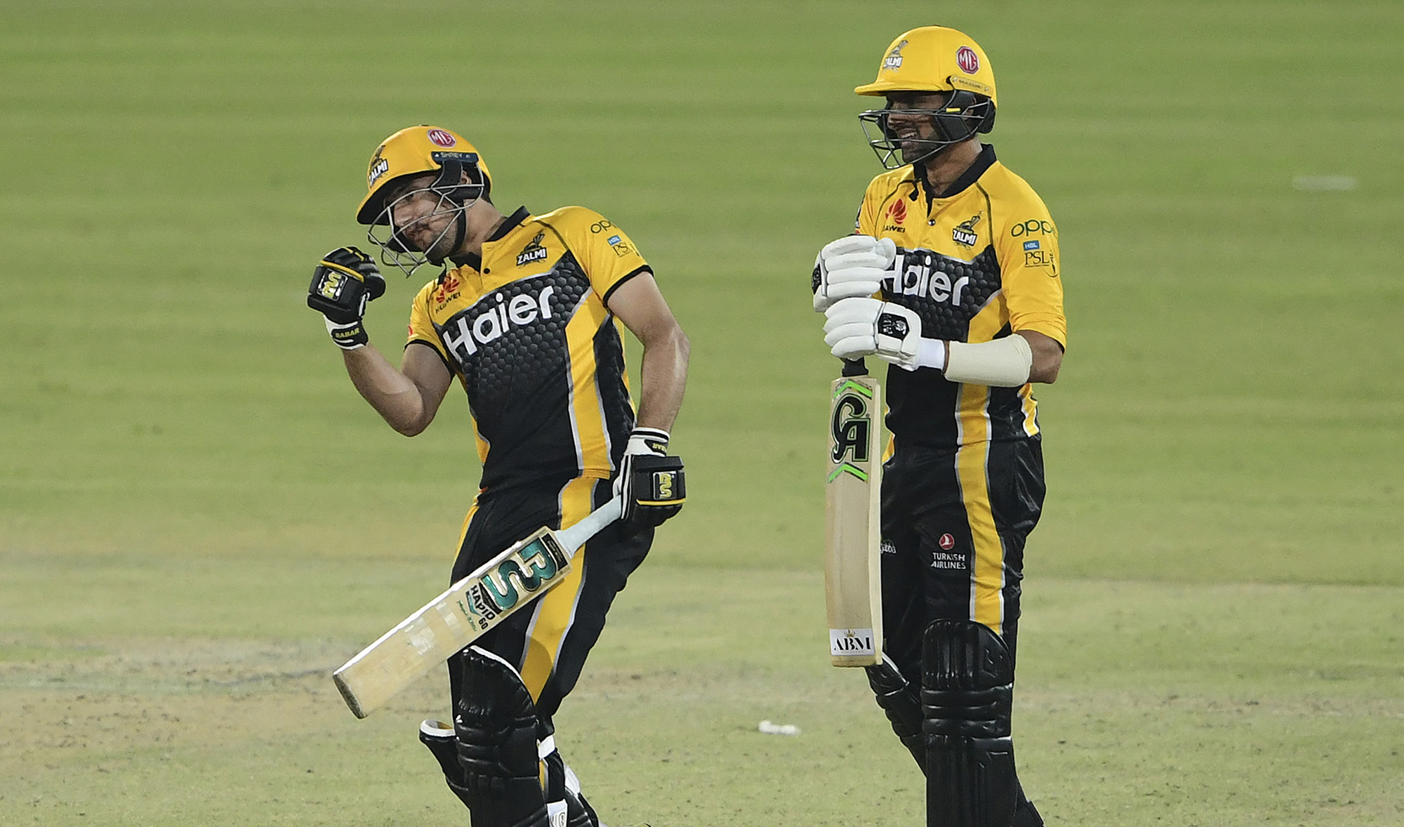 Peshawar Zalmi's Haider Ali, left, and teammate Shoaib Malik celebrate after winning the Pakistan Super League (PSL) T20 cricket match against Multan Sultans at the National Stadium in Karachi, Pakistan on February 23, 2021. (AFP/File)