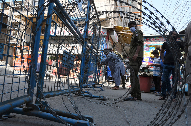 Policemen seal a street at a residential area in Lahore on June 17, 2020 after the COVID-19 cases continue to rise. (AFP/File)