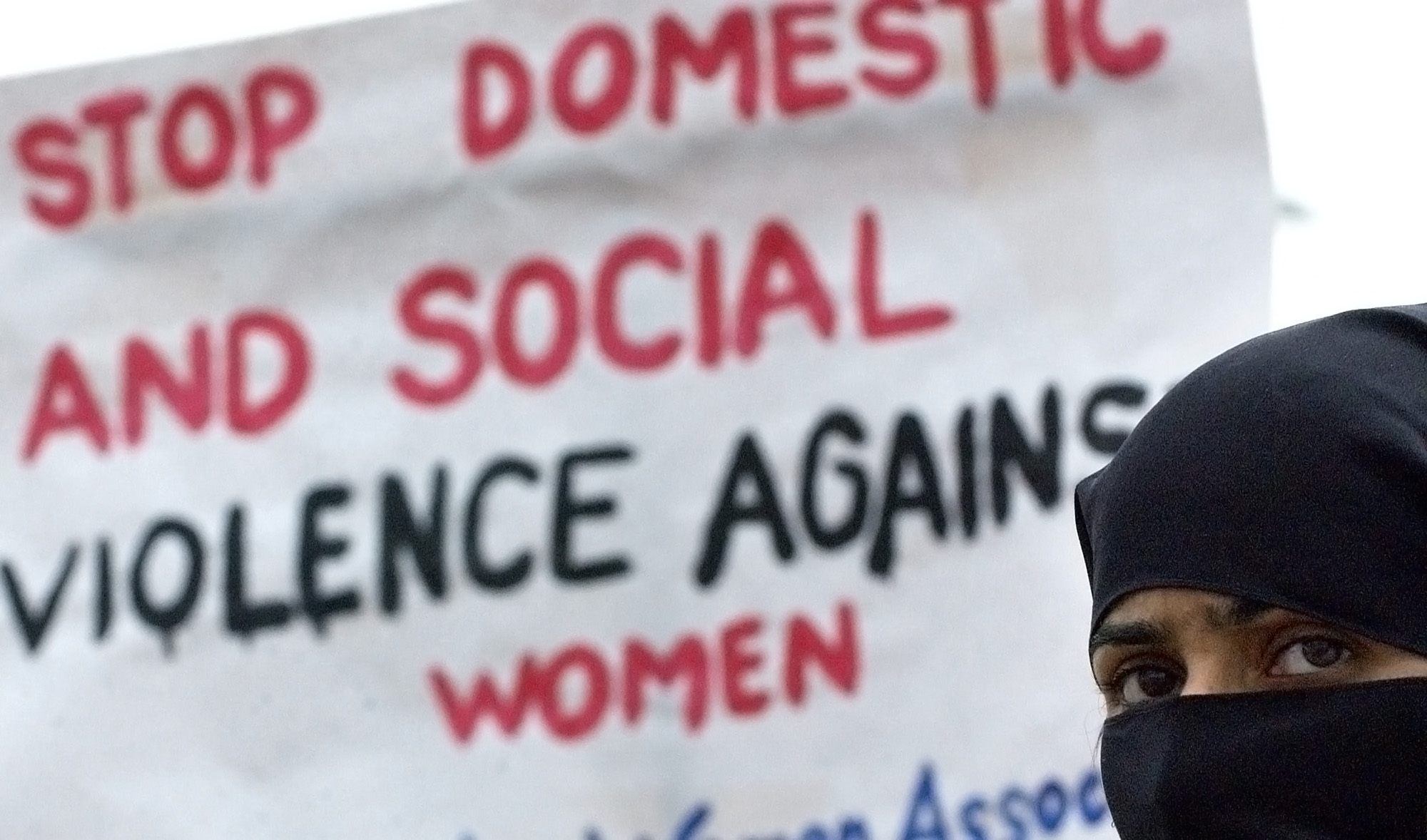 A Pakistani woman holds a placard as she marches with other activists of the Progressive Women's Association (PWA) during a demonstration near The Parliament House in Islamabad, Pakistan, on March 9, 2004. (AFP/File)