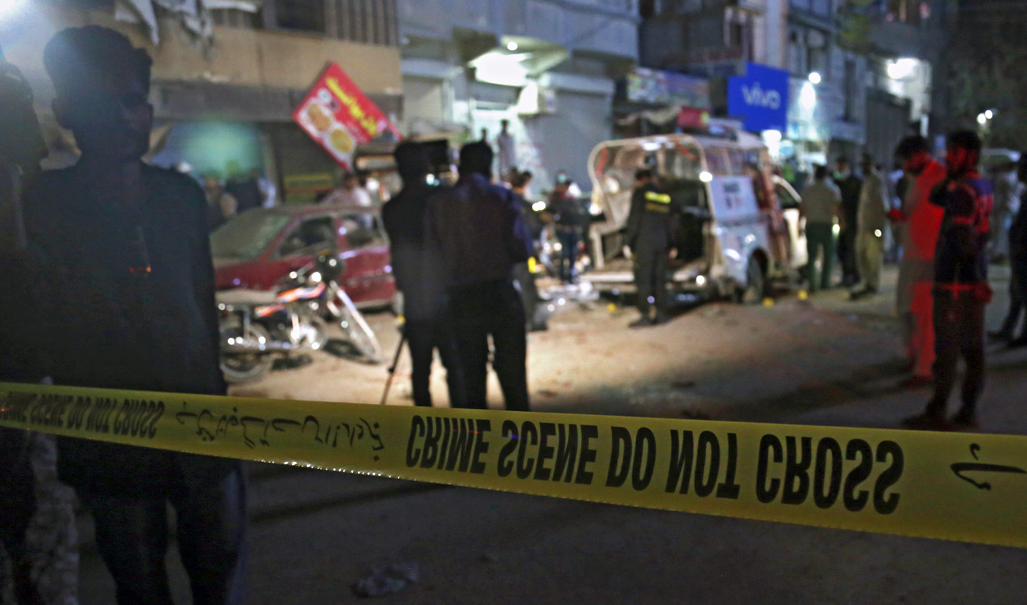 Pakistani security officials inspect the scene of a cracker blast in Karachi, Pakistan, on March 15, 2021. (EPA)