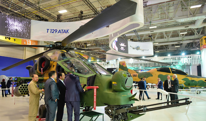 People look at a Turkish attack helicopter “T129 ATAK” during the opening day of the 13th International Defense Industry Fair (IDEF) in Istanbul on May 9, 2017. (AFP/File)
