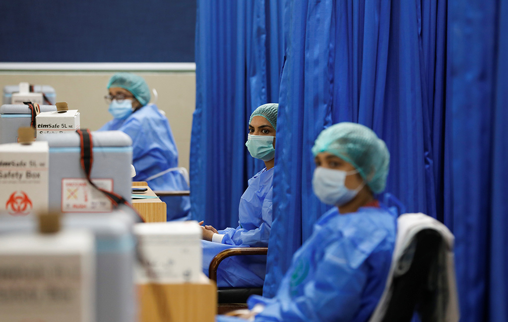 Paramedics sit at their counter while waiting to administer doses of Sinopharm's coronavirus disease (COVID-19) vaccine, donated by China, at a vaccination center in Karachi, Pakistan February 3, 2021. (Reuters/File)