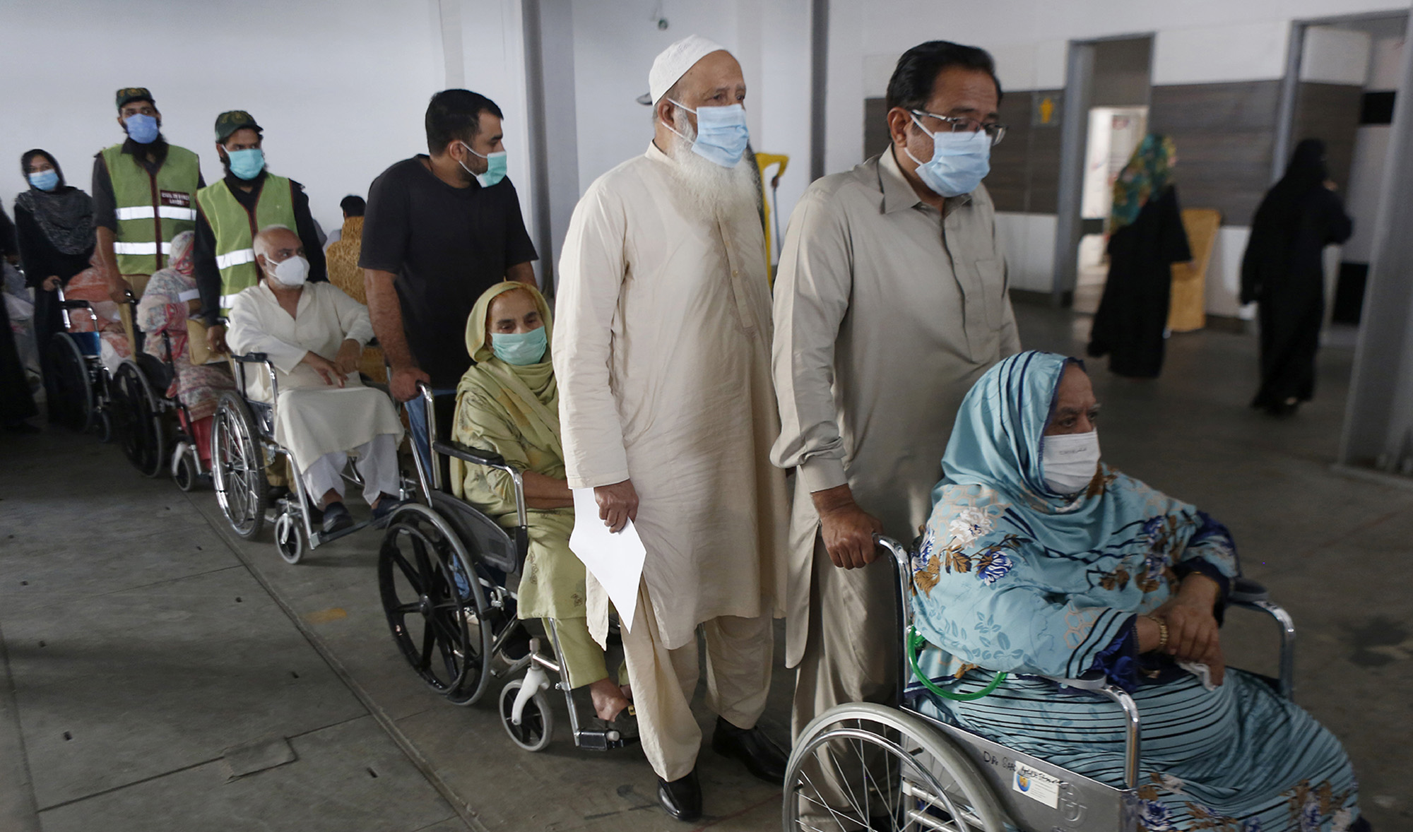 Senior citizens wait their turn to receive the coronavirus vaccine at a vaccination center in Lahore, Pakistan, on March 18, 2021. (AP)