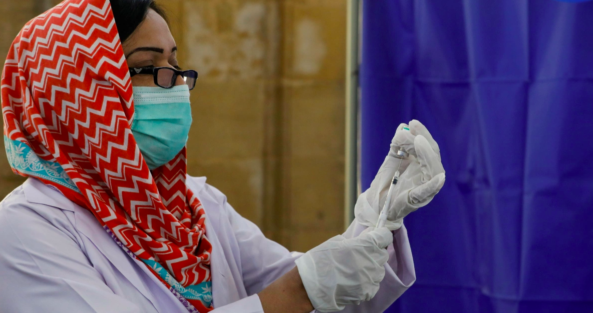 A paramedic prepares a dose of Sinopharm's coronavirus disease (COVID-19) vaccine before administering it to a health worker at a vaccination center in Karachi, Pakistan February 11, 2021. (Reuters/File)