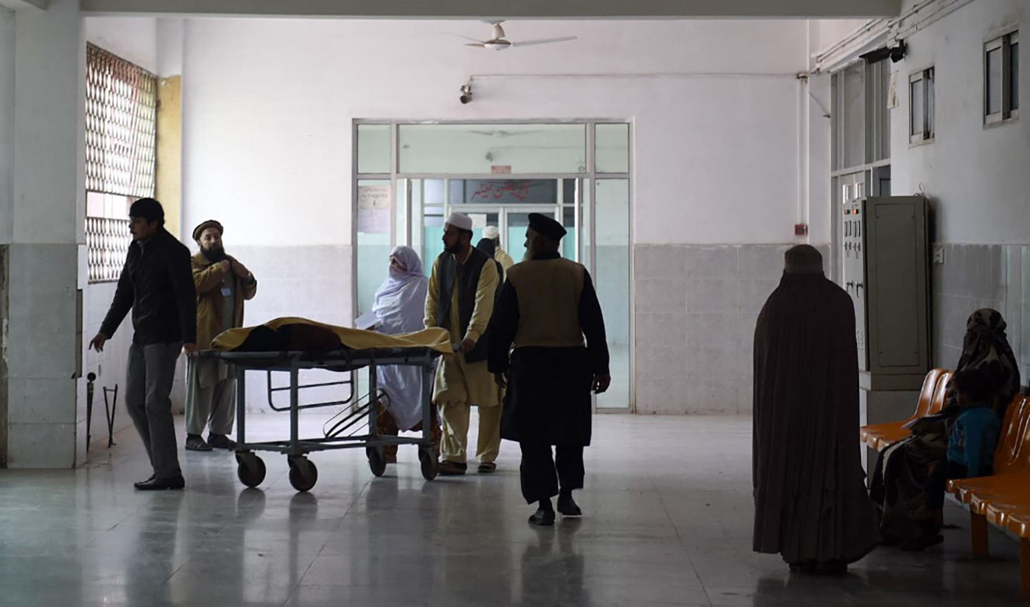 Pakistani relatives tend to a man treated at a hospital in Peshawar on December 26, 2015. (AFP/File)