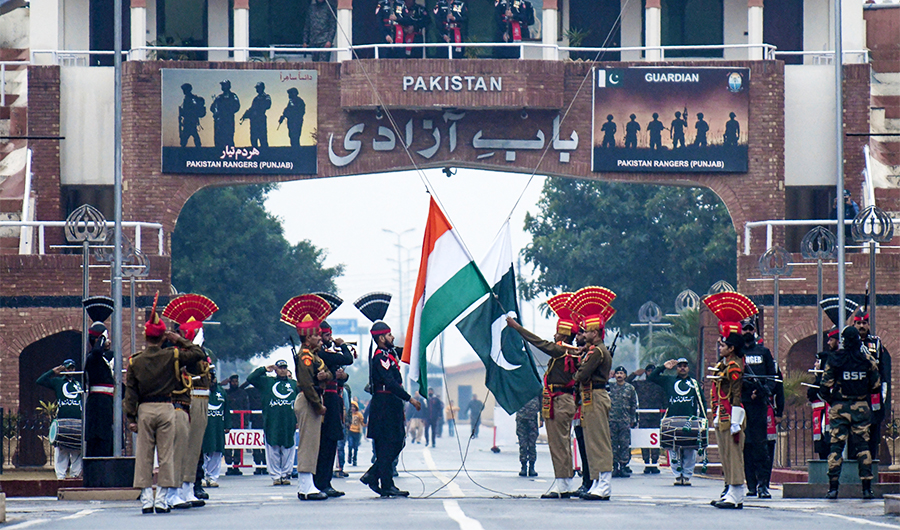 Indian Border Security Force personnel (dressed in brown) and Pakistani Rangers (dressed in black) take part in the Beating Retreat ceremony at the India-Pakistan border in Wagah, on January 6, 2020. (AFP/File)