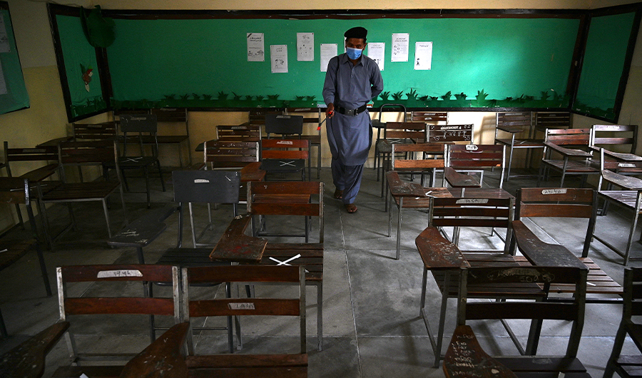 A worker sprays disinfectant in a classroom at a government school in Islamabad on September 14, 2020. (AFP/ FILE)