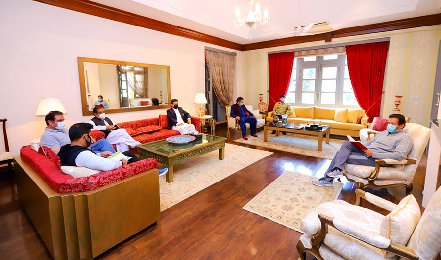 Pakistan's Prime Minister Imran Khan (first right) meets his party officials in Banigala, Pakistan, on March 25, 2021. (Photo courtesy: Shibli Faraz/Twitter)