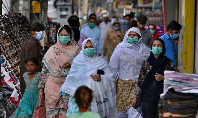 In this file photo a family wearing masks to help curb the spread of the coronavirus visits a market in Rawalpindi, Pakistan, June 2, 2020. (AP)