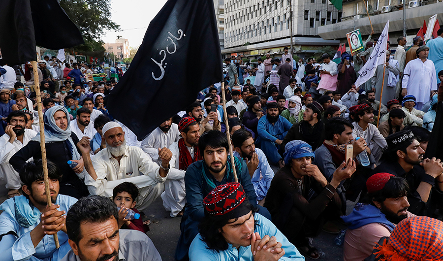 People sit with black flags as they demand an investigation following the deaths of four teenagers in Jani Khel area in Bannu District of Khyber Pakhtunkhwa (KPK) province, during a protest in Karachi, Pakistan March 28, 2021. (REUTERS)