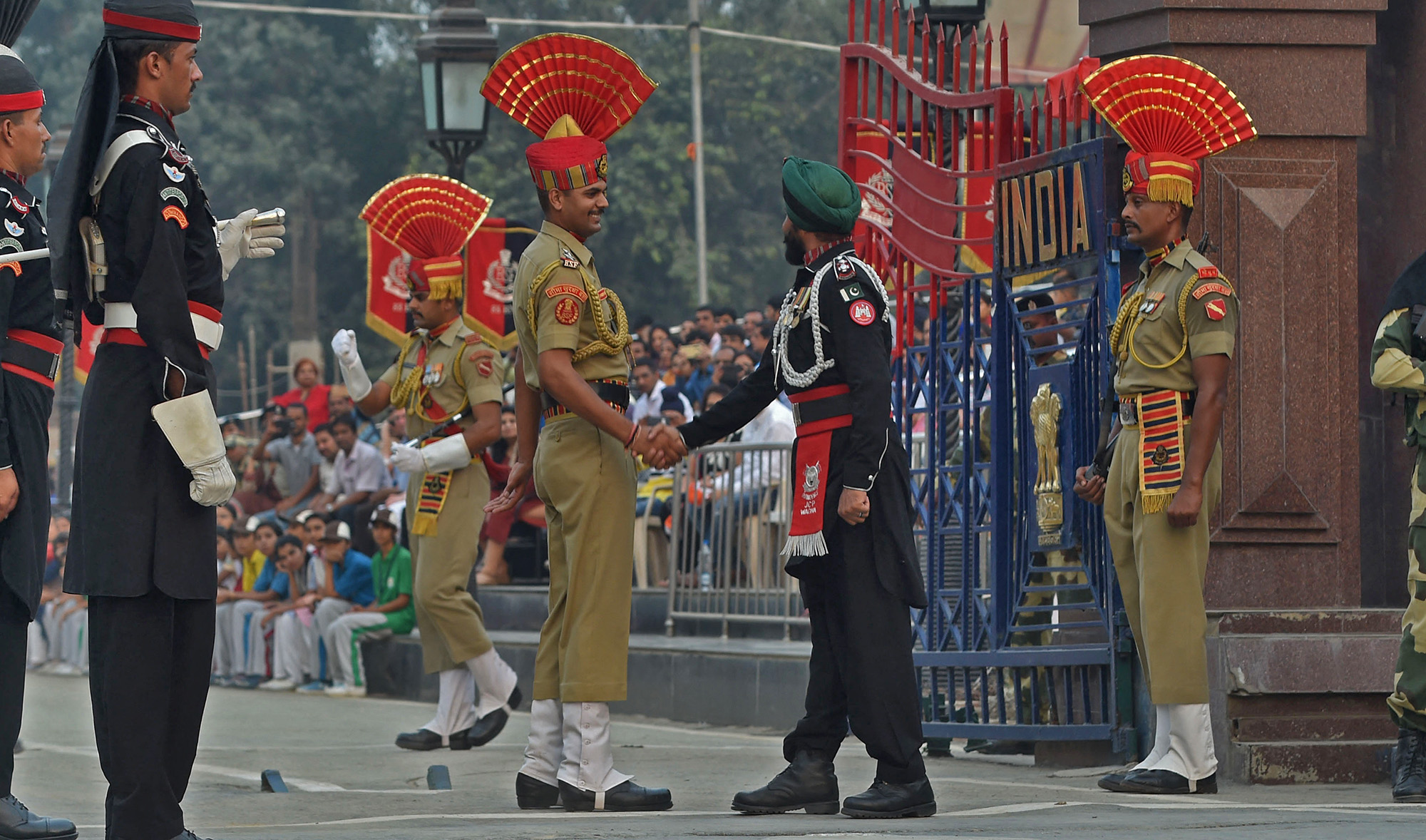 A Pakistani Ranger and an Indian Border Security Force personnel shake hands during a flag off ceremony at the India-Pakistan Wagah Border Post, in Wagah on October 20, 2016. (AFP/File)