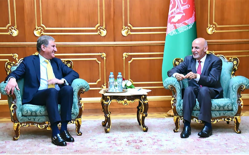 Pakistan's Foreign Minister Shah Mahmood Qureshi (L) smiles during his meeting with Afghanistan's President Ashraf Ghani in Dushanbe, Tajikistan, on March 30, 2021. (Photo courtesy: Shah Mahmood Qureshi/Twitter)