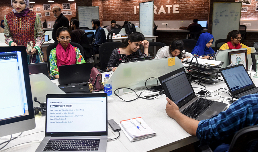 Pakistani youngsters work at their desks at the National Incubation Centre (NIC) in Lahore, Pakistan, on May 24, 2019. (AFP/File)