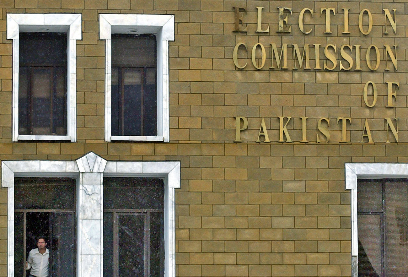 A staff member of the Pakistan Election Commission stands at a window of his office in Islamabad, Pakistan, on September 20, 2007. (AFP/File)