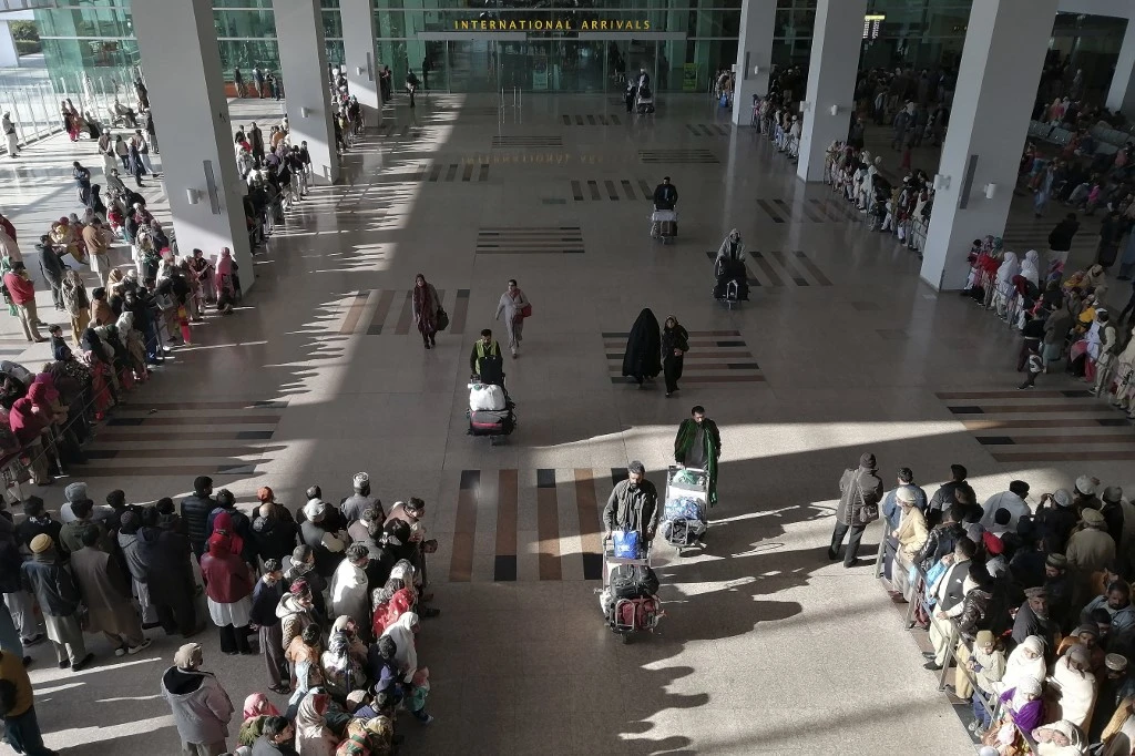 People gather to receive arriving passengers at the international arrival area of Islamabad International Airport in Islamabad on February 3, 2020. (AFP/File)