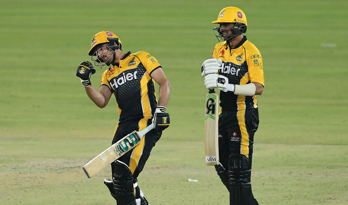 Peshawar Zalmi's Haider Ali, left, and teammate Shoaib Malik celebrate after winning the Pakistan Super League (PSL) T20 cricket match against Multan Sultans at the National Stadium in Karachi, Pakistan on February 23, 2021. (AFP/File)