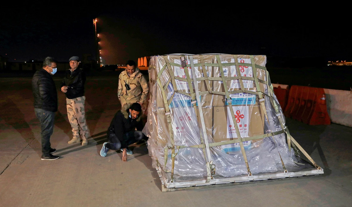 Personnel unload an aircraft carrying the first batch of doses of the Sinopharm vaccine against the coronavirus disease (COVID-19) after it arrived at Baghdad International Airport on March 2, 2021. (REUTERS)