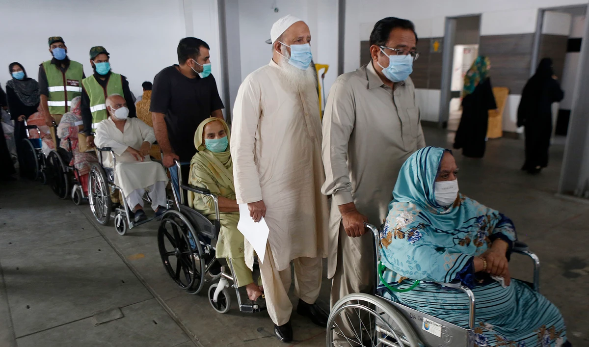 Senior citizens wait their turn to receive the coronavirus vaccine at a vaccination center in Lahore, Pakistan, on March 18, 2021. (AP)