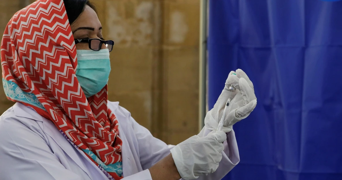 A paramedic prepares a dose of Sinopharm's coronavirus disease (COVID-19) vaccine before administering it to a health worker at a vaccination center in Karachi, Pakistan February 11, 2021. (Reuters/File)