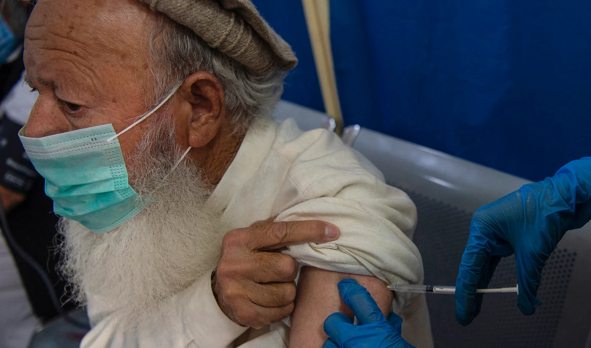 A senior citizen receives a dose of a COVID-19 vaccine at a vaccination center in Peshawar, Pakistan on March 10, 2021. (AFP)