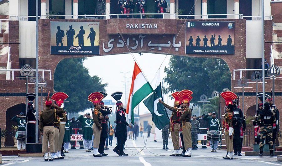Indian Border Security Force personnel (dressed in brown) and Pakistani Rangers (dressed in black) take part in the Beating Retreat ceremony at the India-Pakistan border in Wagah, on January 6, 2020. (AFP/File)