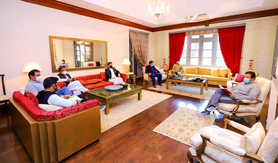 Pakistan's Prime Minister Imran Khan (first right) meets his party officials in Banigala, Pakistan, on March 25, 2021. (Photo courtesy: Shibli Faraz/Twitter)