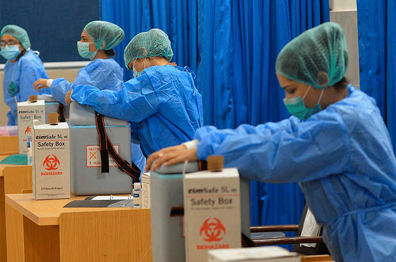 Medical attendants prepare to vaccinate health workers with Chinese-made Sinopharm Covid-19 vaccine at a vaccination centre in Karachi, Pakistan, on February 3, 2021. (AFP/File)