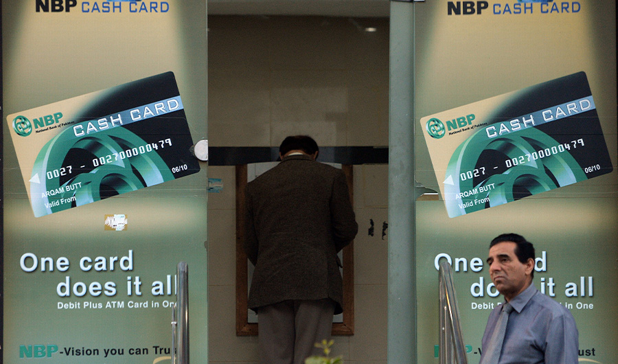 This photograph taken on March 4, 2015 shows a Pakistani resident waiting to withdraw currency from an ATM in Islamabad. (AFP/File)