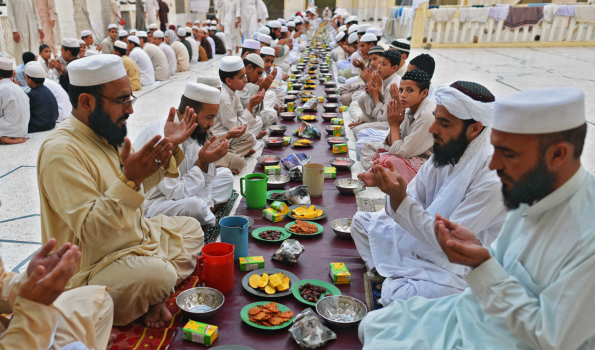 Pakistani Muslims pray before breaking their fast at a mosque during the first day of amadan in Peshawar, Pakistan, on July 11, 2013. (AFP/File)