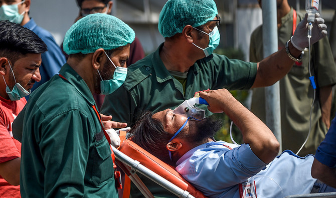 Paramedics personnel shift a patient on a stretcher into the hospital in Karachi on February 18, 2020. (AFP/ File)