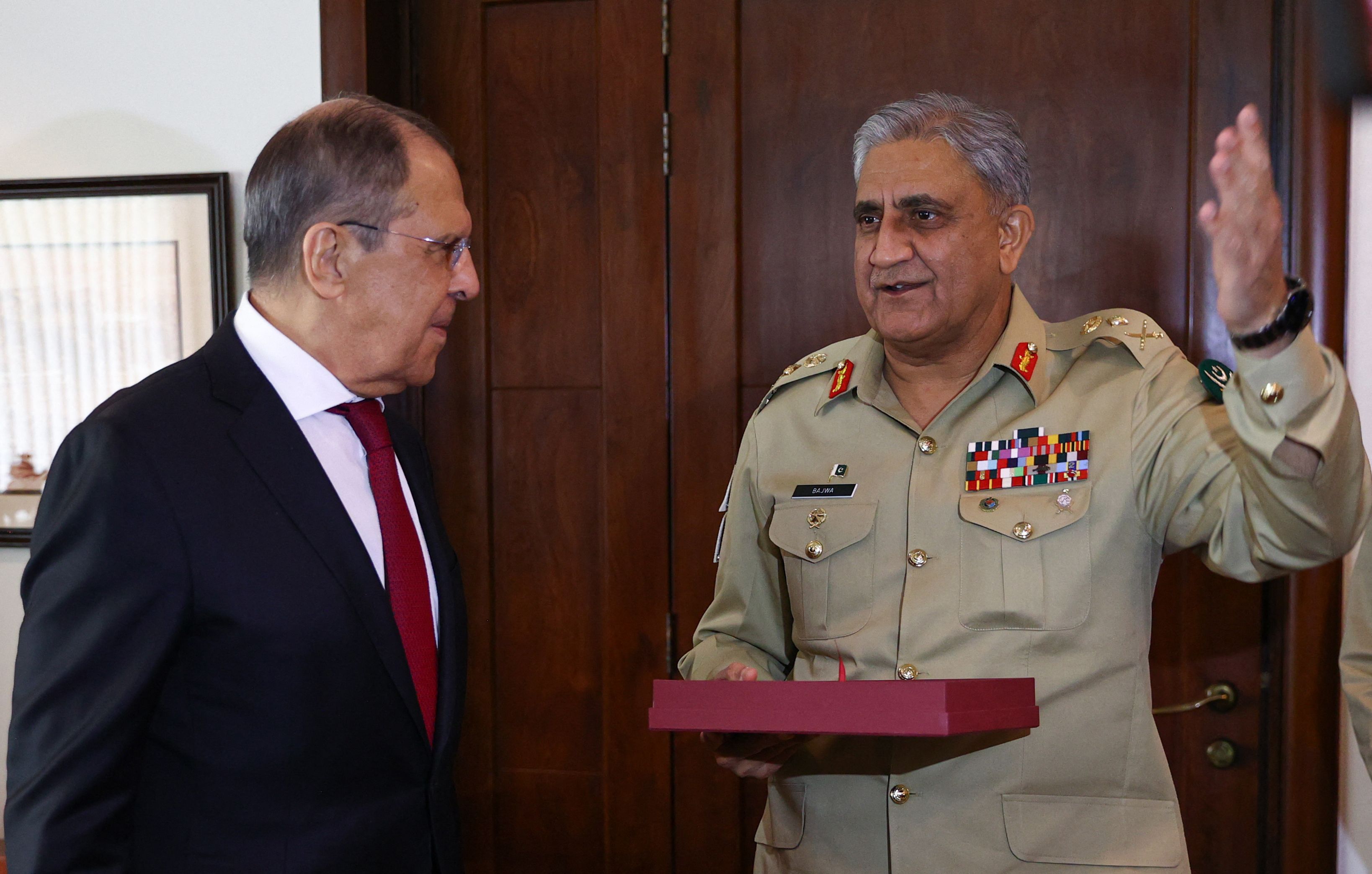 This handout picture taken and released on April 7, 2021 by the Russian Foreign Ministry shows Russian Foreign Minister Sergei Lavrov (L) speaking with Pakistan's army chief General Qamar Javed Bajwa during their meeting in Rawalpindi. (AFP PHOTO / Russian Foreign Ministry)