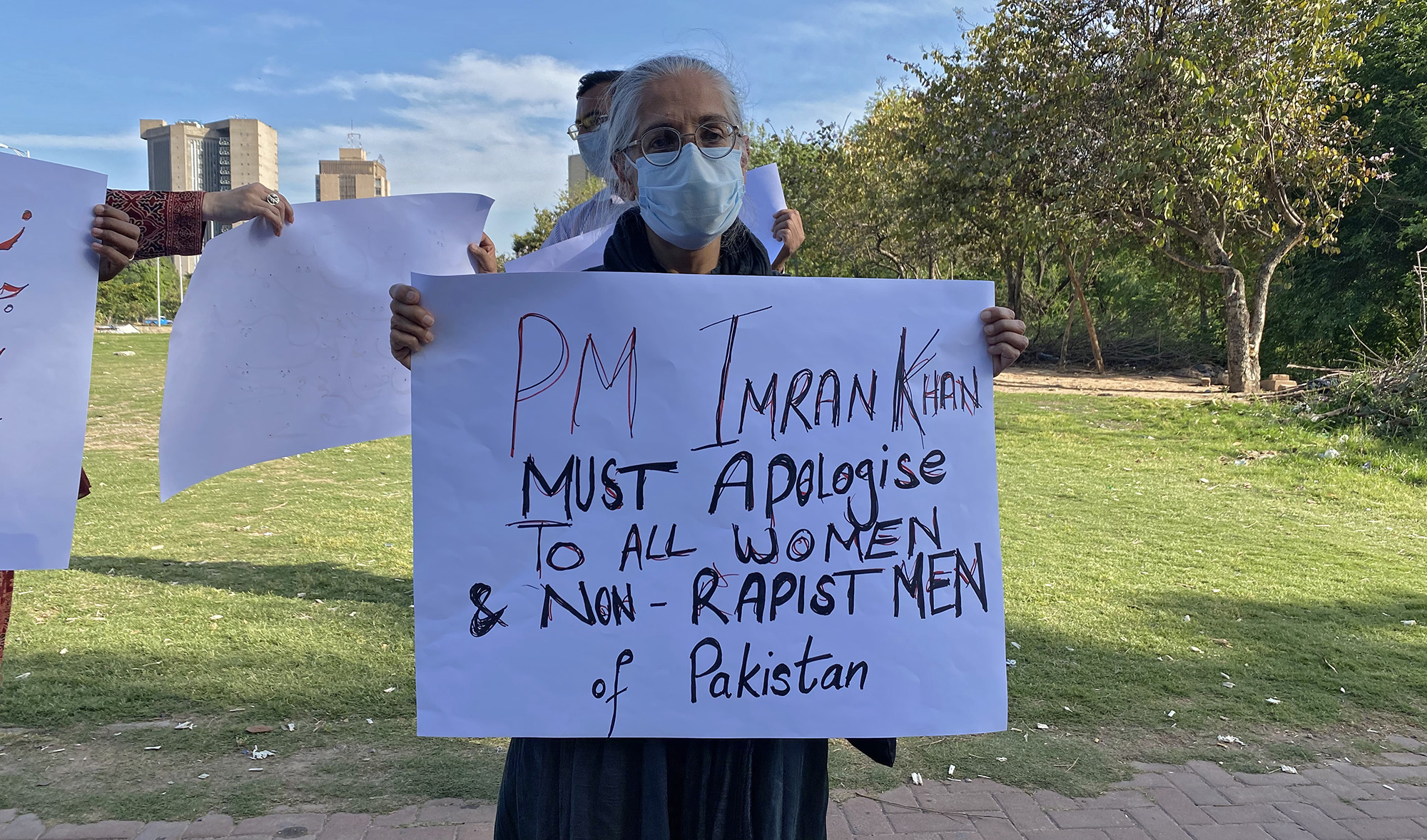 A women's rights activist, Tahira Abdullah, holds a placard at a protest rally in front of the National Press Club in Islamabad on April 8, 2021, demanding an apology from Prime Minister Imran Khan over his remarks on sexual violence against women in Pakistan. (AN Photo)