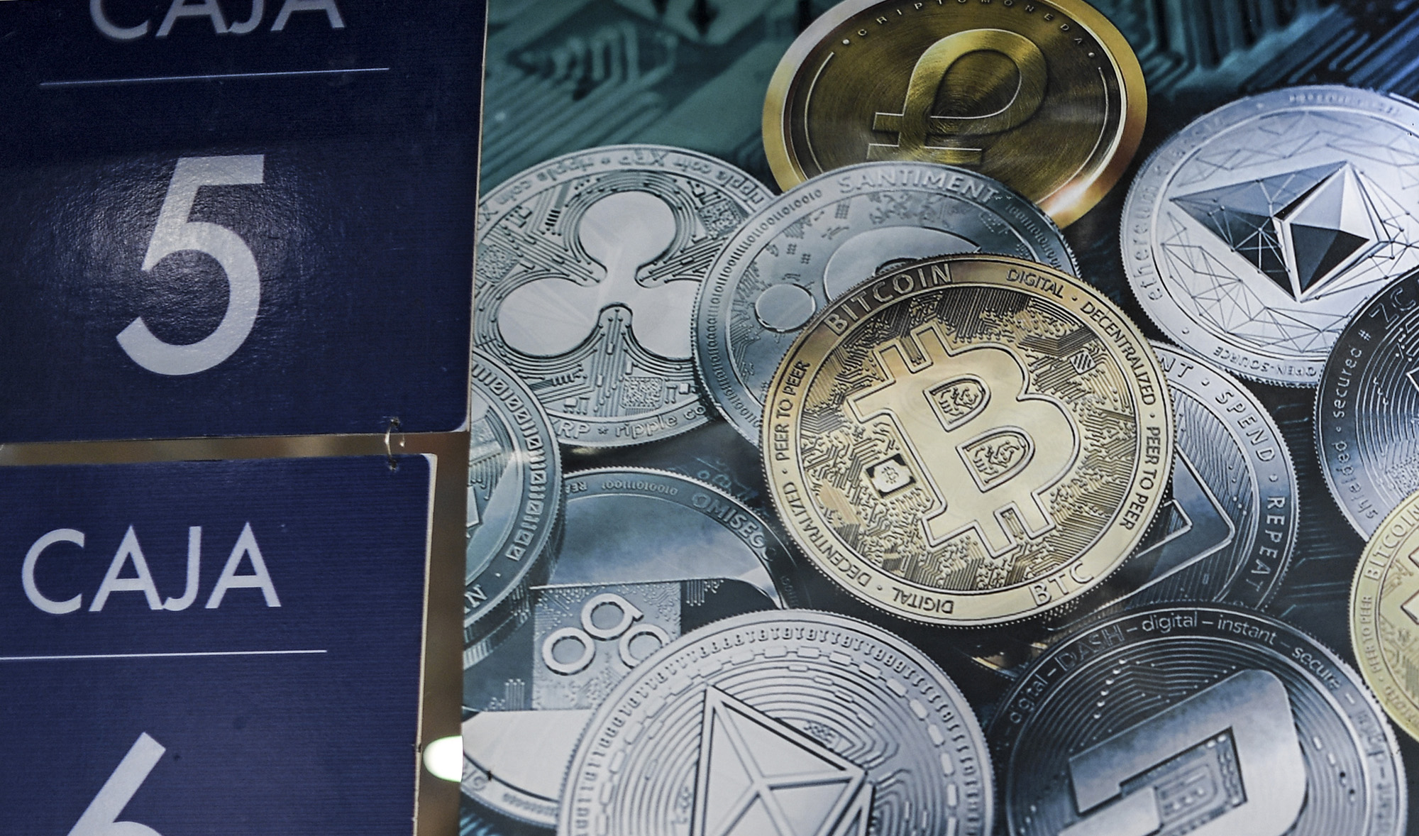 A poster with cryptocurrencies at a store in Caracas, Venezuela, on December 28, 2019. (AFP/File)