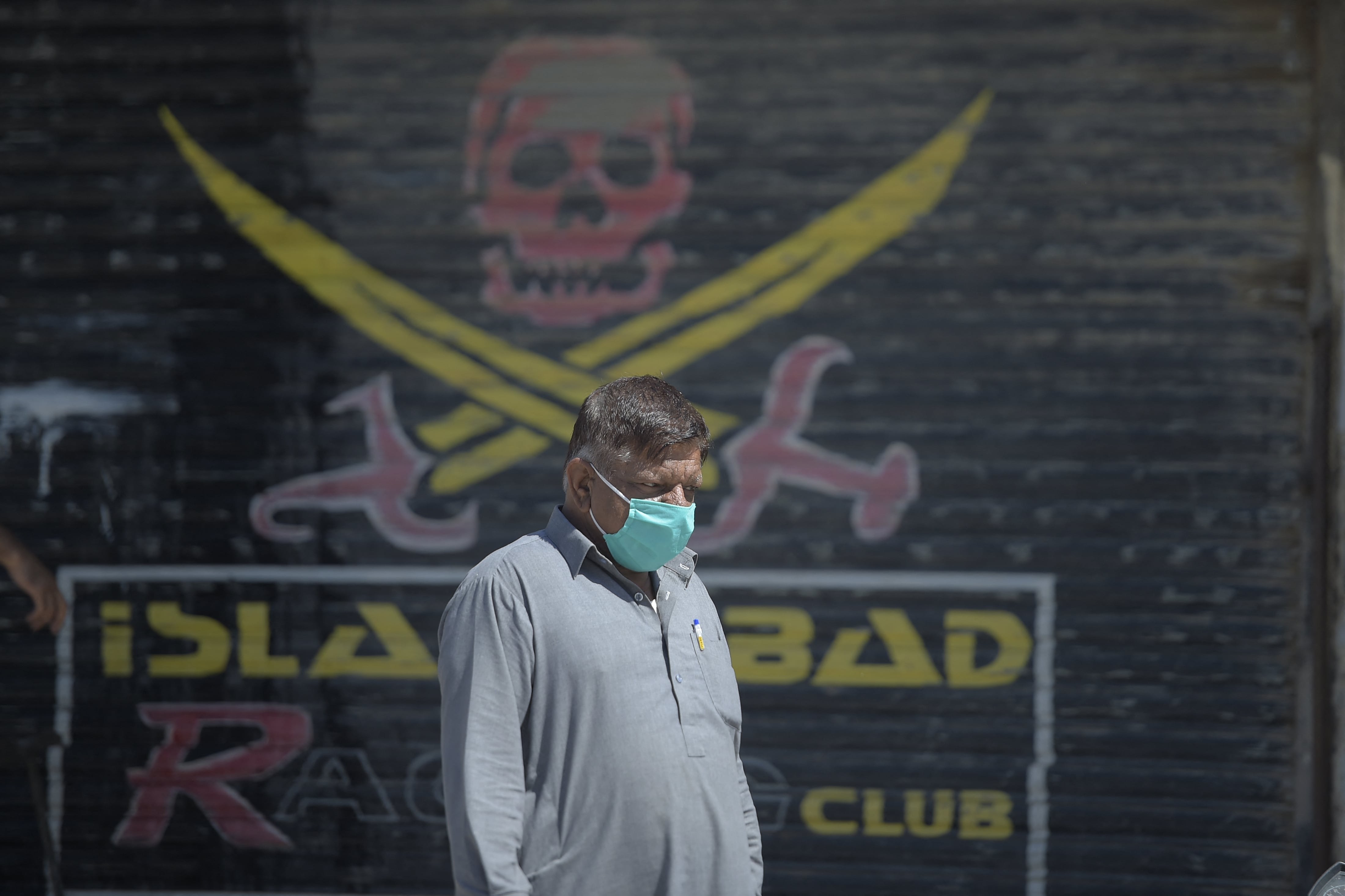 A Pakistani man walks past a closed shop of a market area in Karachi on March 22, 2020. (AFP/ File )