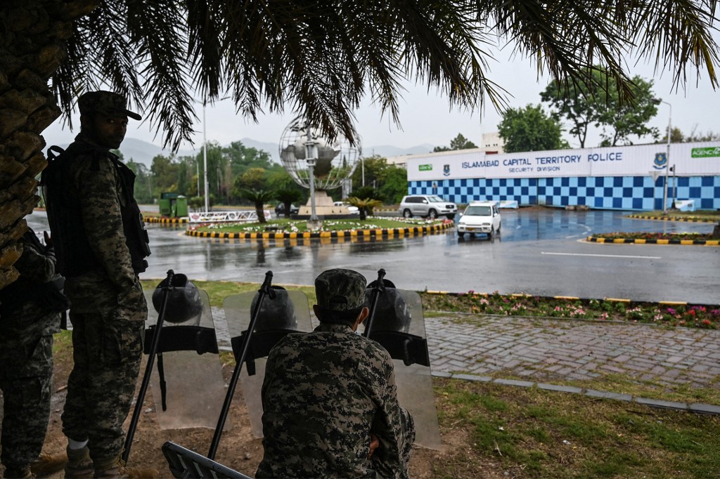 Paramilitary soldiers stand guard in front of the French Embassy in the Red Zone which was secured with shipping containers by the authorities to beef up security following violent anti-France protests, in Islamabad on April 15, 2021. (AFP)