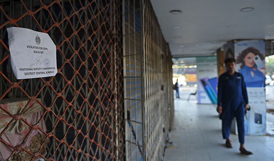 A man walks through a market that was closed by the local authorities after facing violations over social distancing rules against Covid-19 in Karachi, Pakistan, on April 5, 2021. (AFP/File)