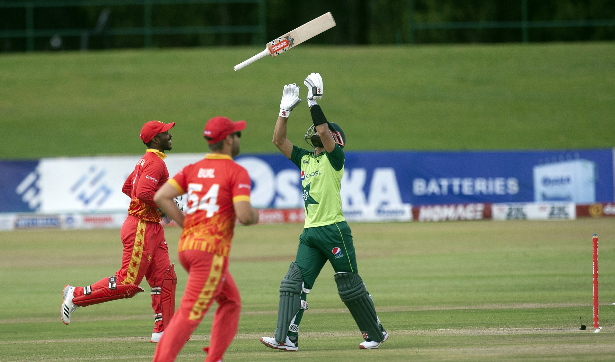Pakistan batsman during Mohammad Rizwan throws his bat in the air after been dismissed during the T20 cricket match between Zimbabwe and Pakistan at Harare Sports Club, in Harare, on April 23, 2021. (AP)